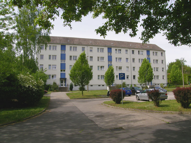 kleines Bild - Eingang Ernst-Borsbach-Straße 16-17-18 in Bitterfeld, hat 24 Wohnungen, 2 - 4 RWE, 44 - 75 m<sup>2</sup>, Fernwärme, alle WE mit Balkon Süd- bzw. Westseite. PKW-Stellplätze vorhanden. Viel Grün und Gartennutzung möglich. Mehrere Garagenkomplexe im Wohngebiet vorhanden.